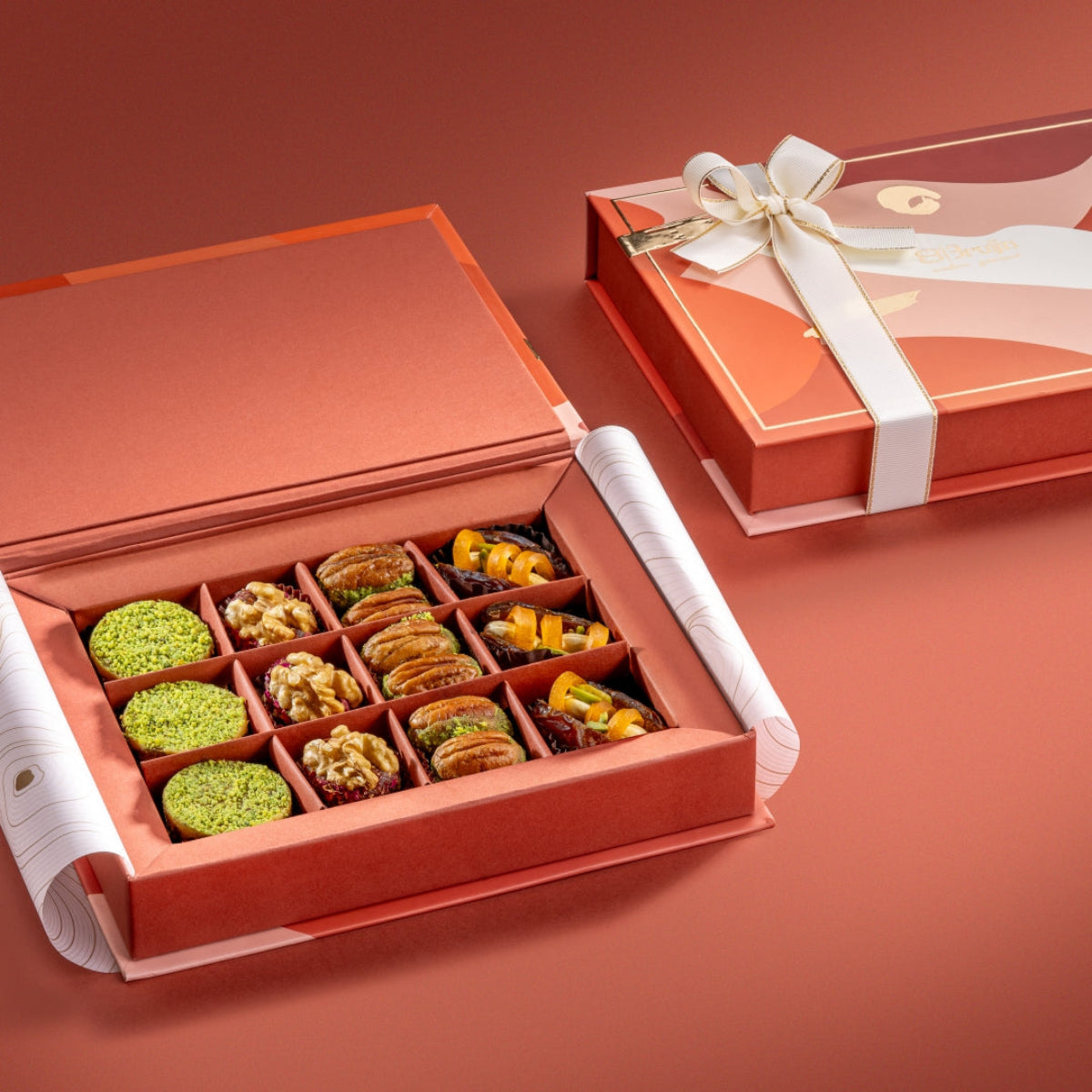 Open Assorted Collection Box with luxury patterned lid, showcasing neatly arranged Ranginak, Persian Rose Delight, walnut bites, and paan-inspired sweets.