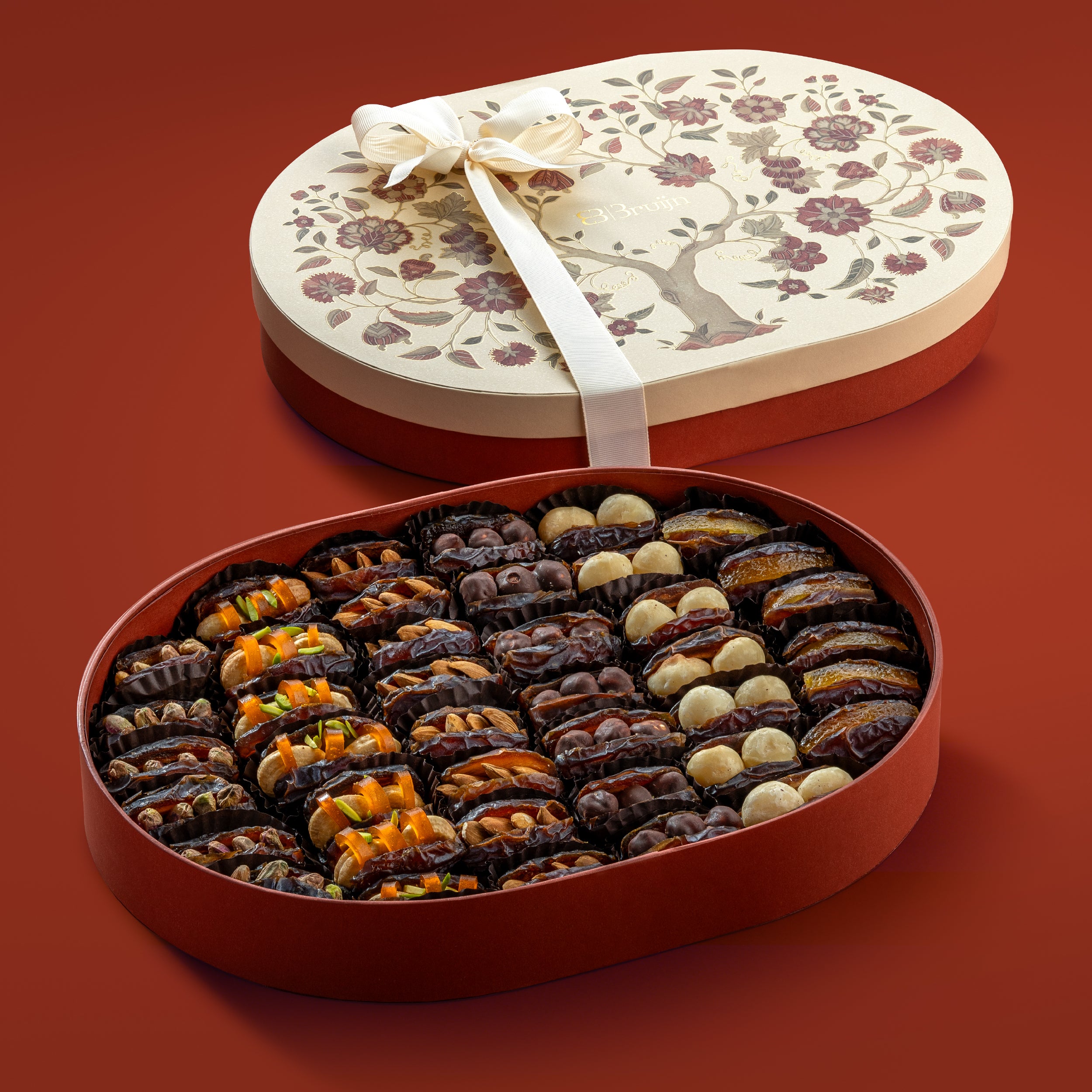 Open tree of life box with 42-43 assorted mejdool dates stuffed with pistachios, dried mango & cashew nuts, mamra almonds, chocolate hazelnuts, macadamia nuts and orange peel.