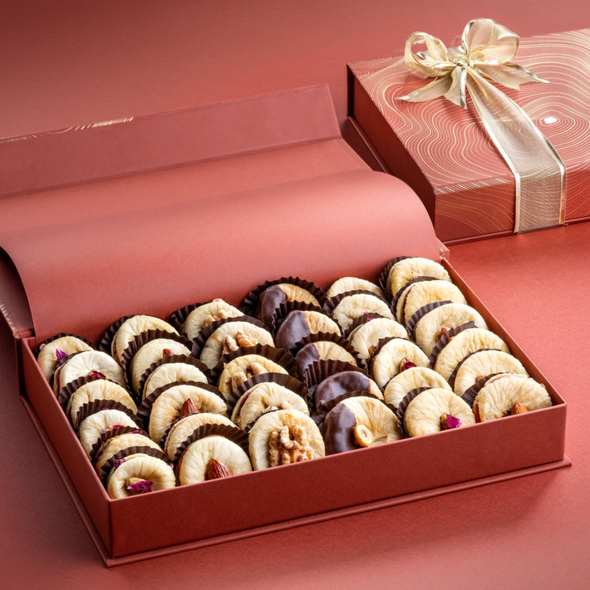 Open rust gift box of assorted Turkish dried figs stuffed with pecans, almonds, walnuts, cranberries, hazelnuts and strawberries.