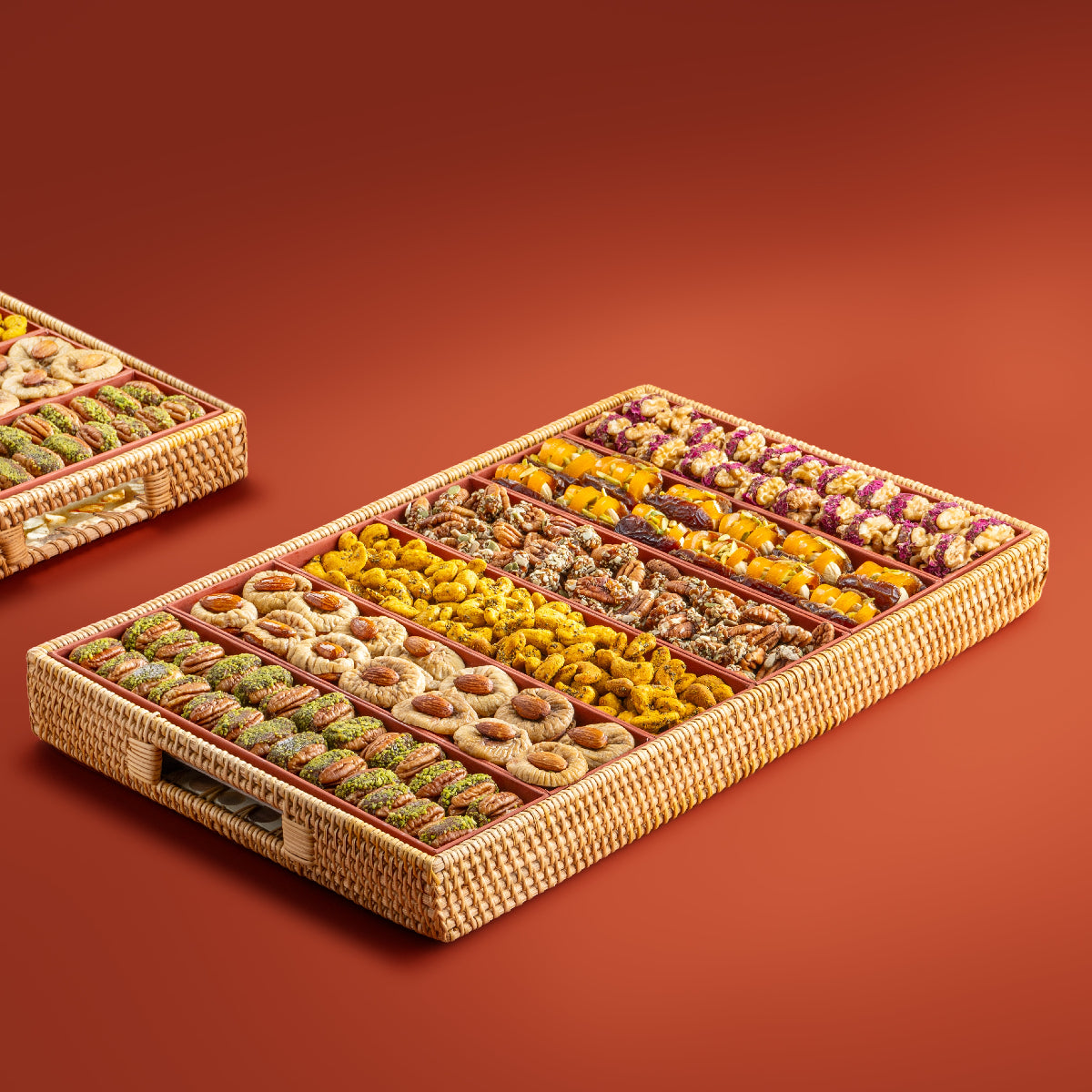 Large rectangular rattan tray with six sections of assorted nuts, figs, and dates.