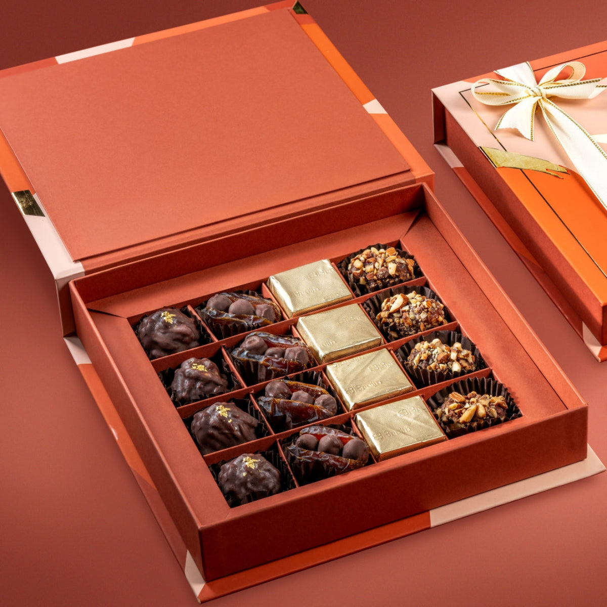 Open Bruijn chocolate box with 24K almond rocks, chocolate hazelnut stuffed dates, and dark chocolate tamriyas.
