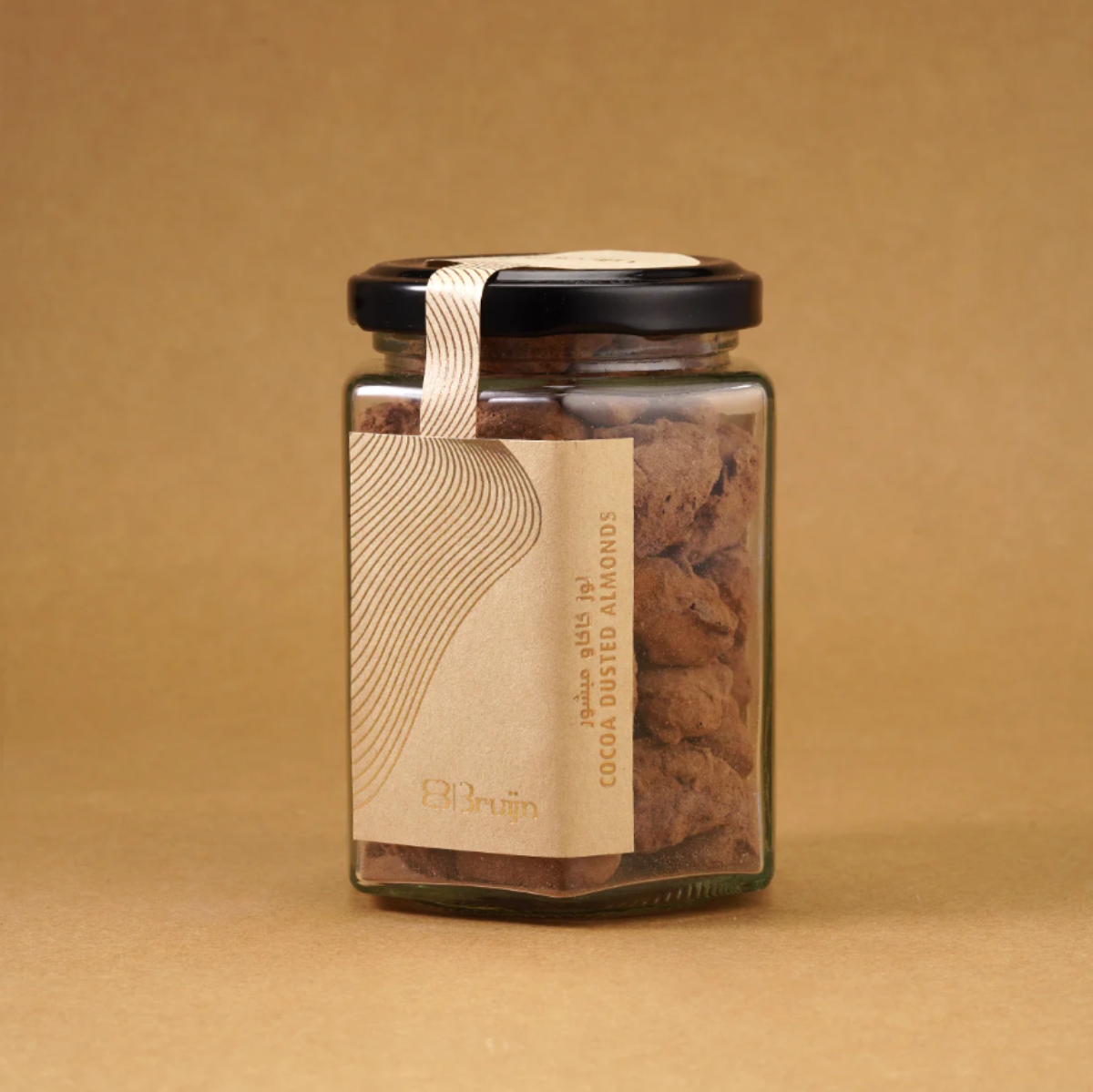 Glass jar filled with cocoa dusted almonds, a healthy indulgence.