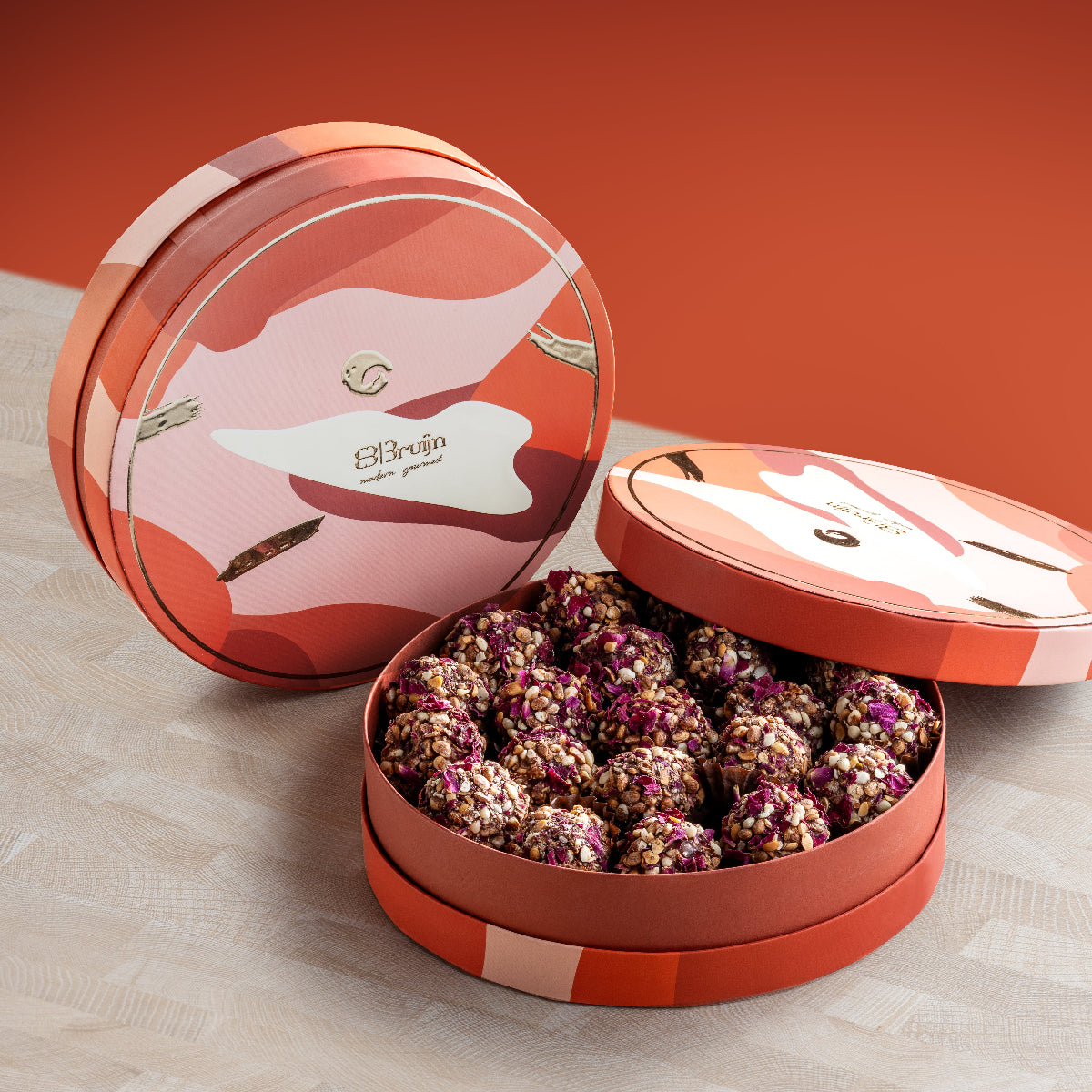 Round gift box with 475g of signature date truffles coated in diced nuts, peanut butter, and almondette, perfect for healthy gifting and celebrations.
