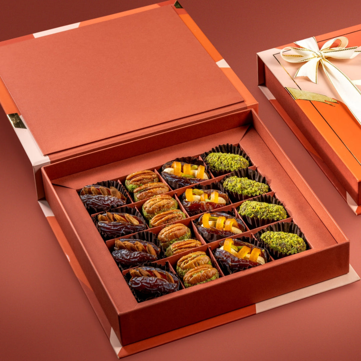 Bruijn Candid Box with stuffed dates, nut truffles, pecan wholes, and mango cashew dates arranged neatly.