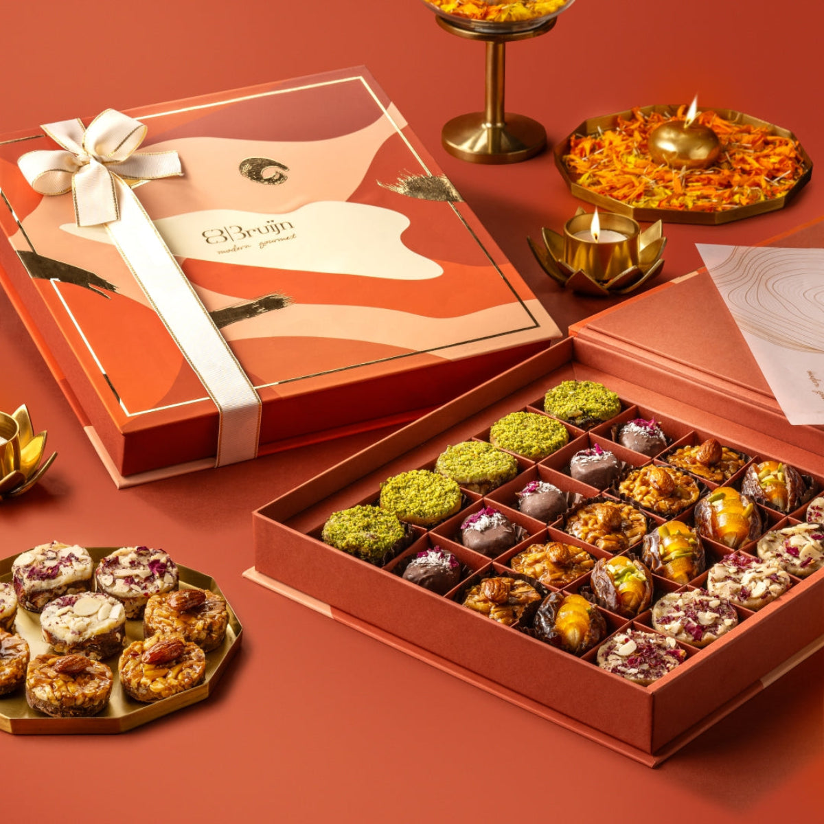 Festive Box with 25 assorted pieces including Persian Rose Delight, stuffed dates, paan bites, and Ranginak in a luxury gift box.