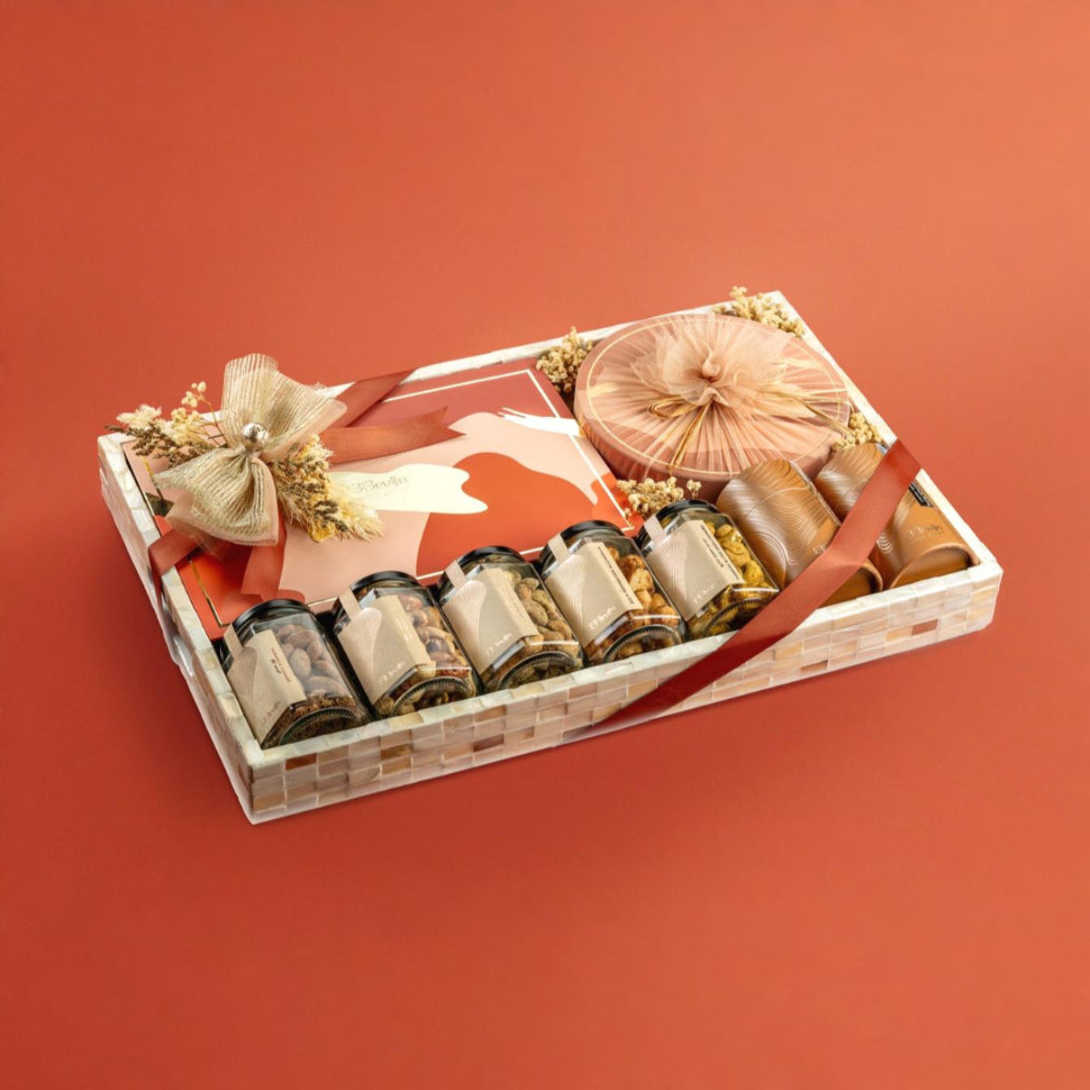 Festive Mother of Pearl tray with nut jars, Regal box, Round box, and apple chips, wrapped for gifting.