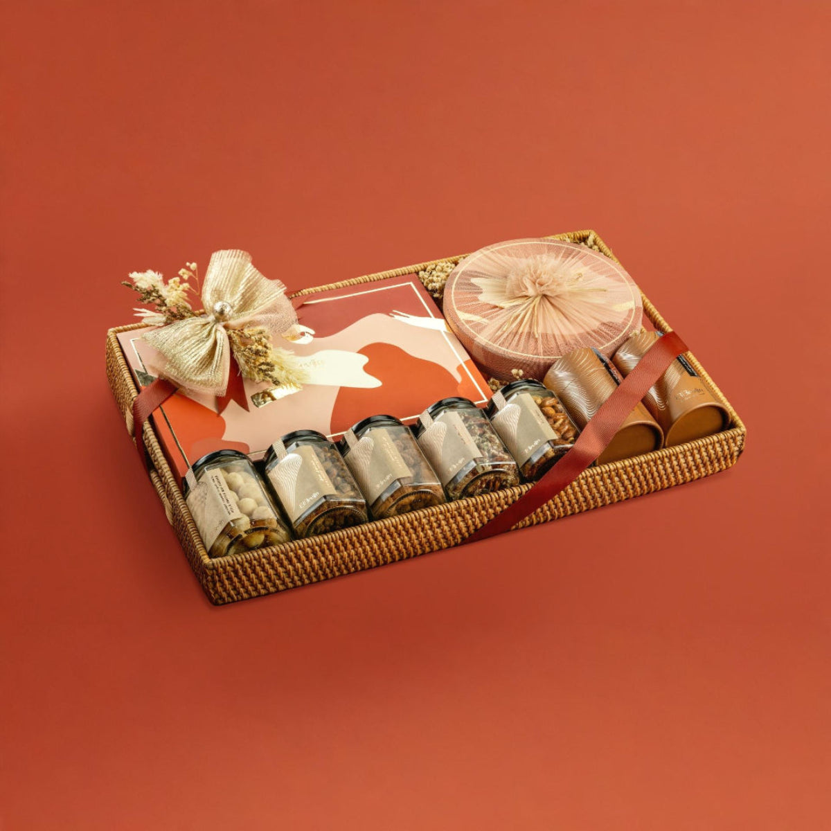 Festive Rattan tray with nut jars, Regal box, Round box, and apple chips, wrapped for gifting.