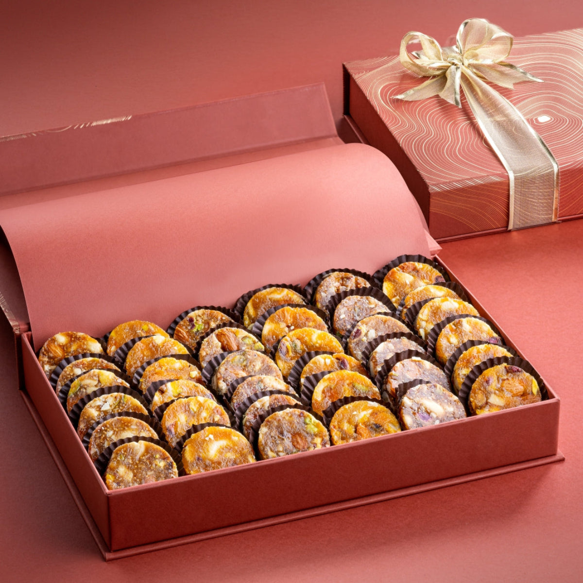 Open Rust Box with 34–36 pieces of fig and nut delights, made with roasted nuts rolled in fig and apricot paste, in luxury packaging.