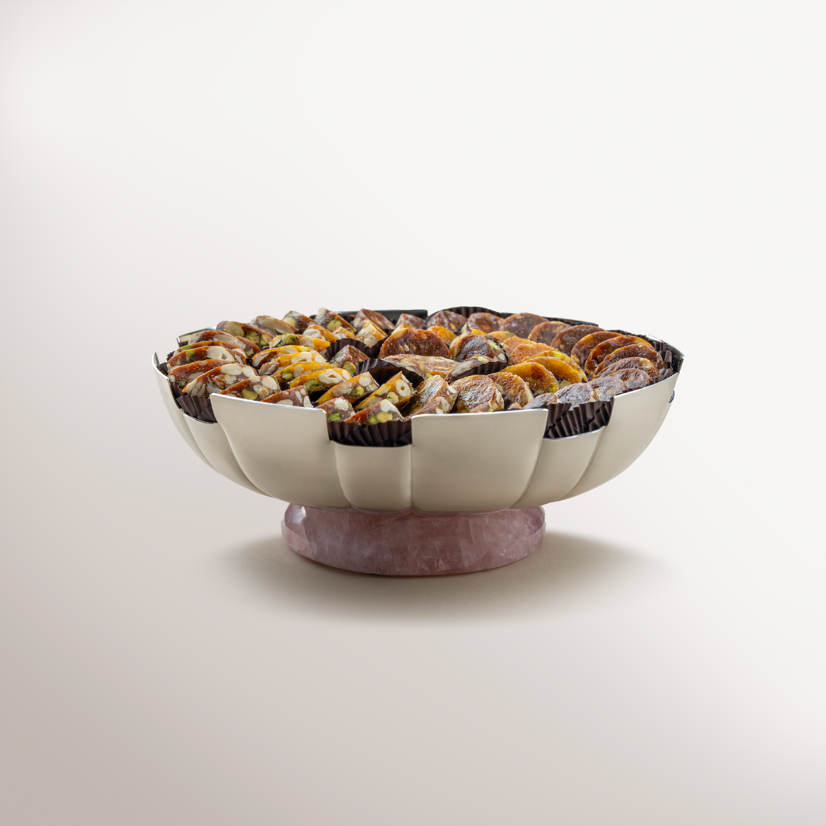 Fluted Silver bowl with Rose Quartz wrapped in net, filled with fig & apricot nut delights.