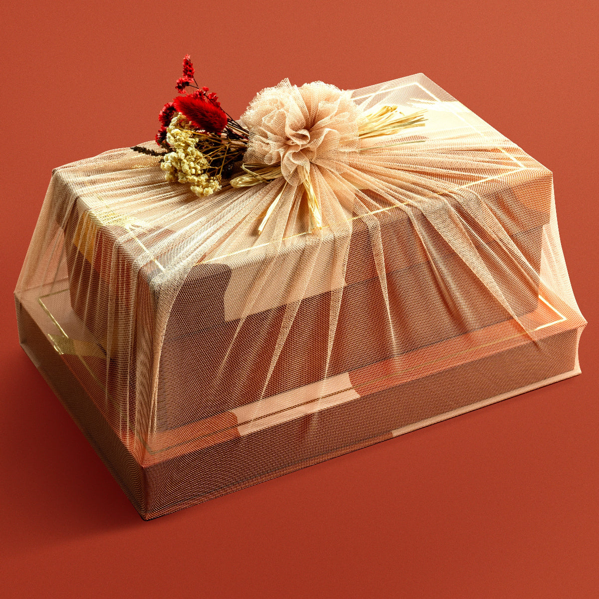 Tower gift set wrapped in golden net with floral decor, holding festive boxes of nuts and stuffed dates.