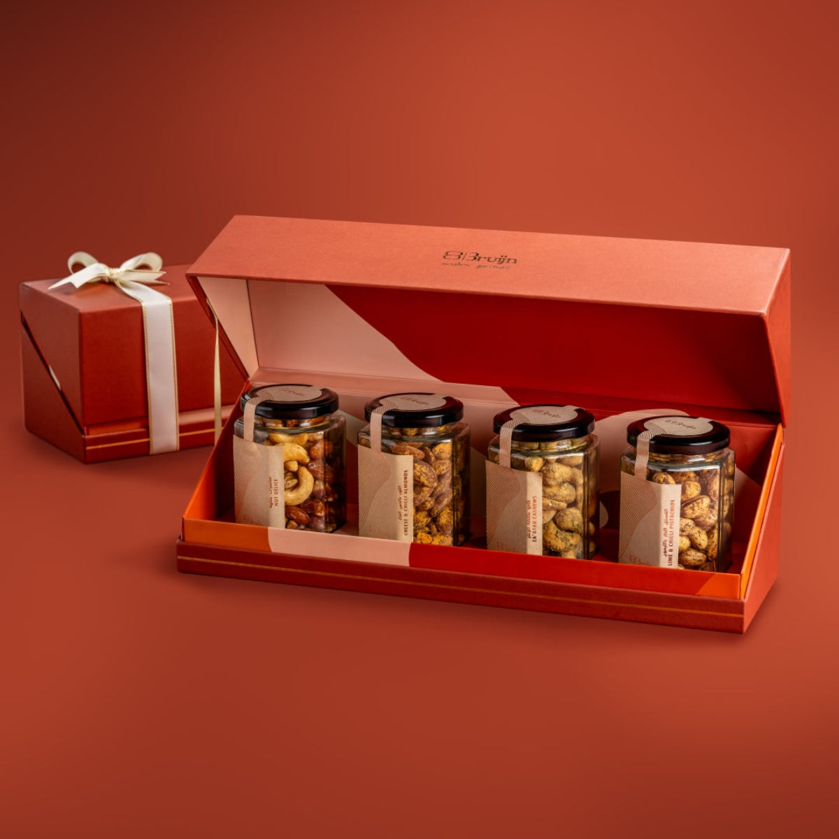 Open Bruijn festive jar box with Salted Caramel Nut DΓ©lice, Cheese & Chilli Almonds, Zaβatar Cashew, and Lime & Chilli Pistachio jars.