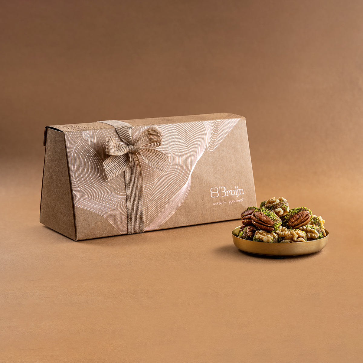Assorted American pecans and Chilean walnuts stuffed with dates & pistachio, neatly arranged in a gift box.