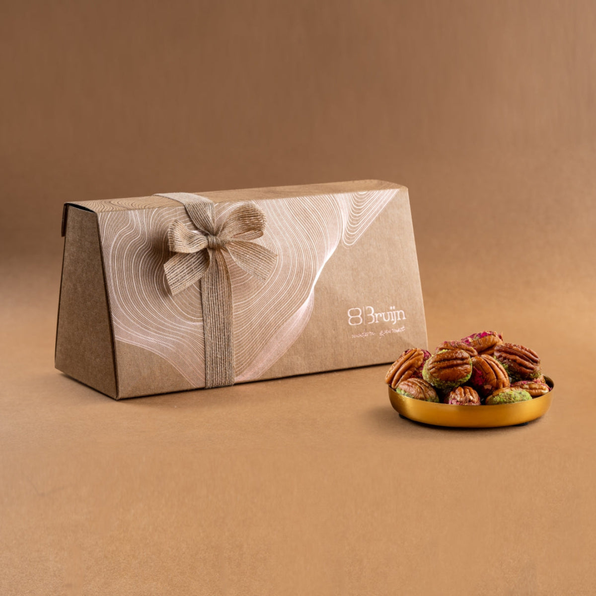 Gift box of American pecans stuffed with dried fruit, rose petals, and pistachios, presented in eco-friendly packaging with a ribbon bow.