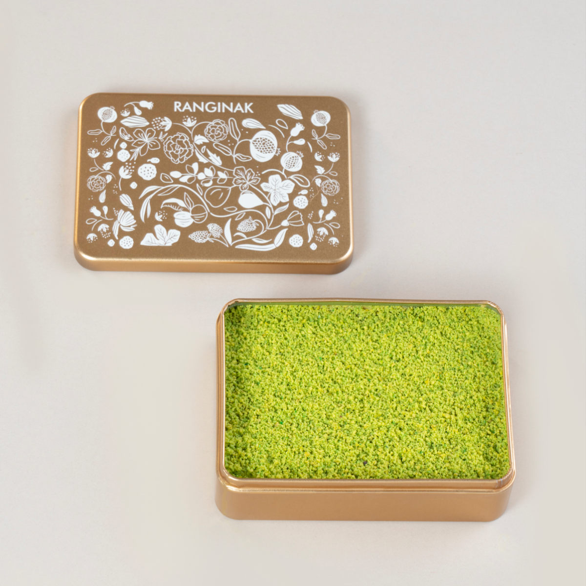 Elegant tin box filled with 370g of Ranginak, a Persian delicacy made from dates, walnuts, chickpea flour, and spices.