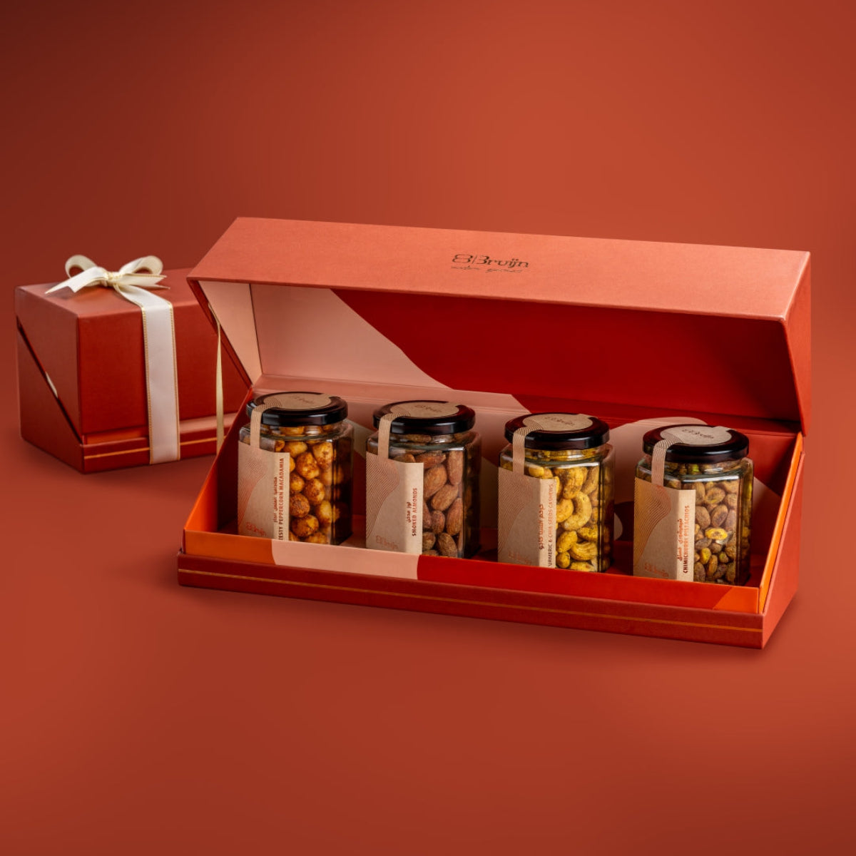 Open Bruijn festive jar box with Zesty Peppercorn Macadamia, Smoked Almonds, Turmeric & Chia Cashew, and Chimichurri Pistachio jars.