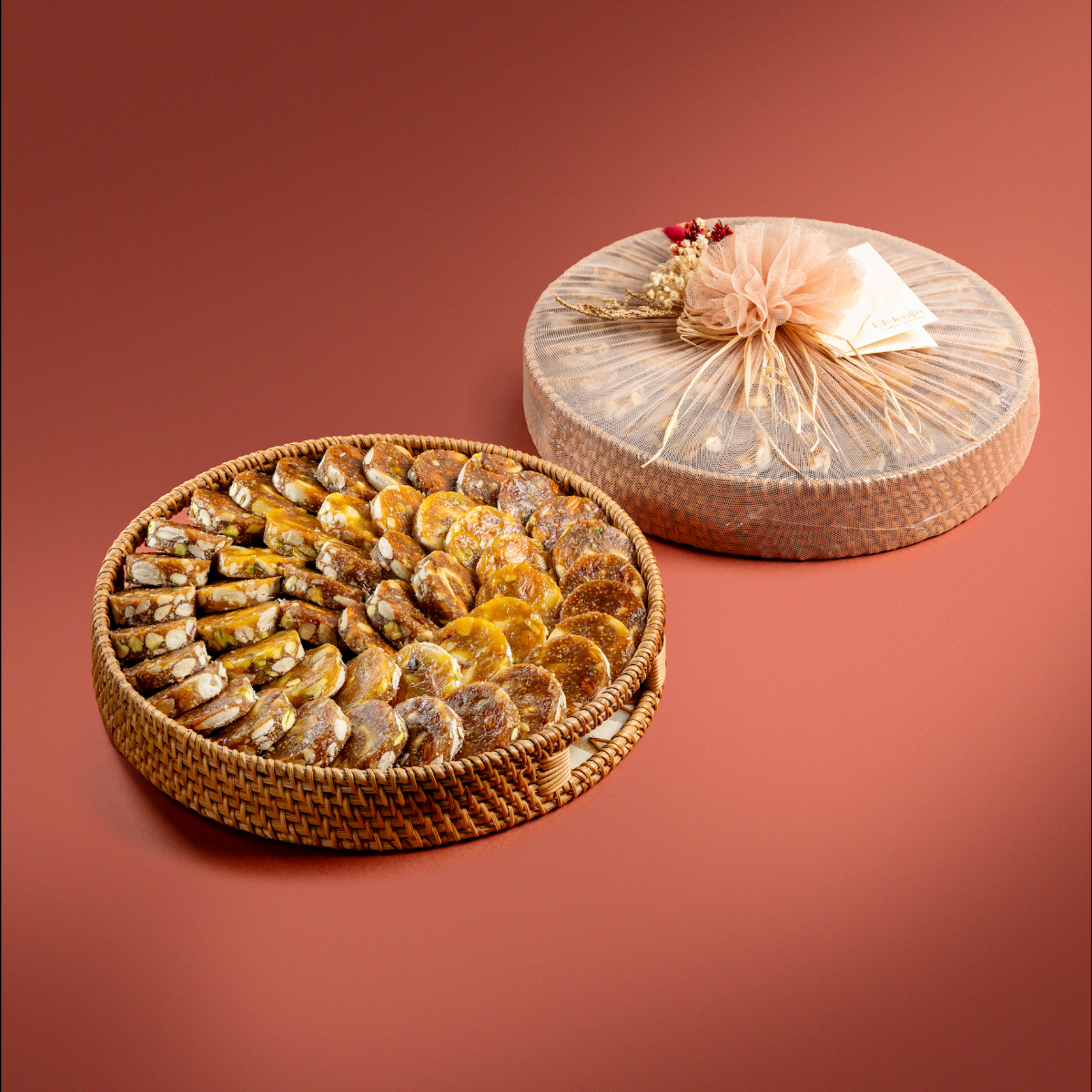 12" and 14" sustainable round trays wrapped in net, filled with fig & apricot nut delights.
