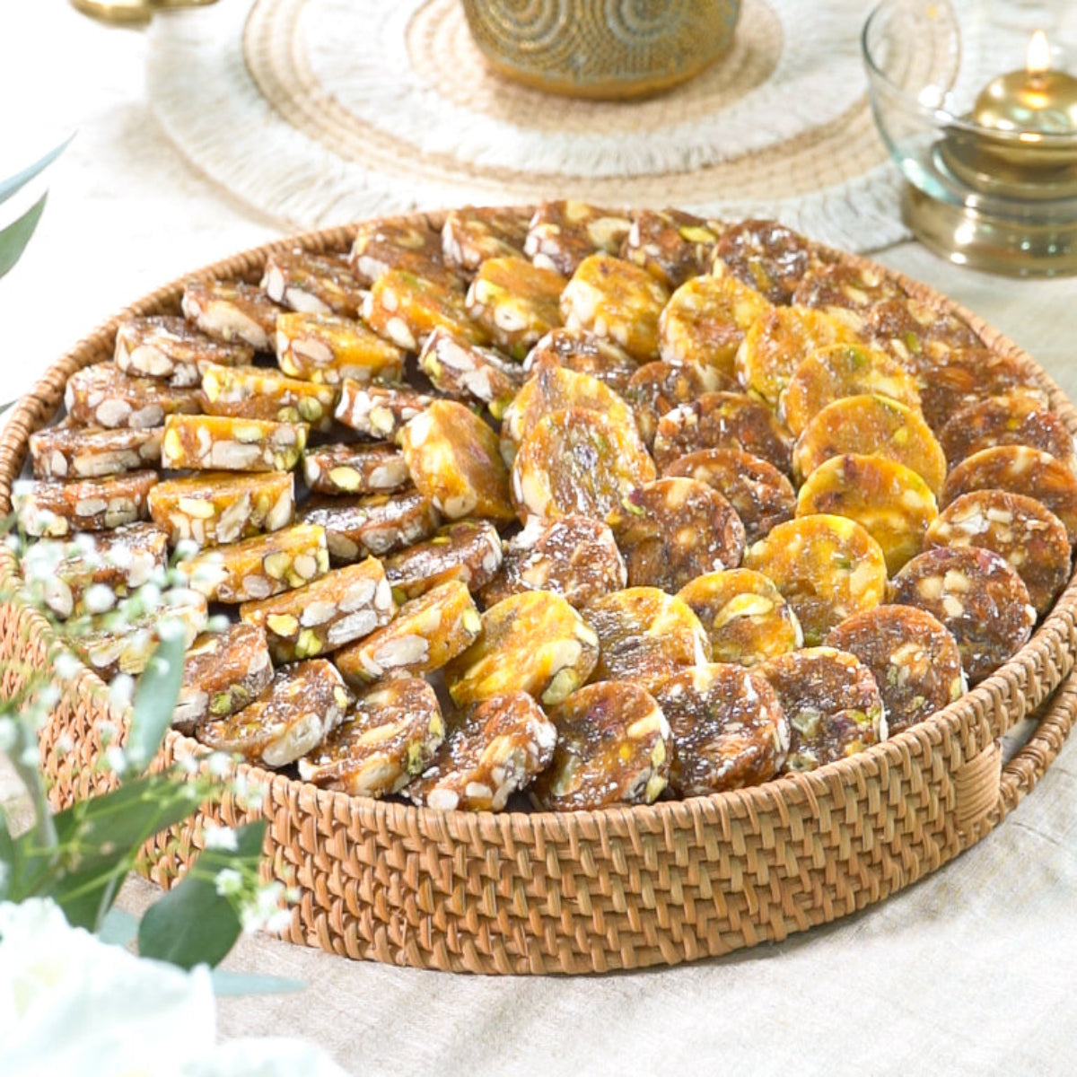 Large sustainable round tray with assorted fig and nut bites arranged neatly.