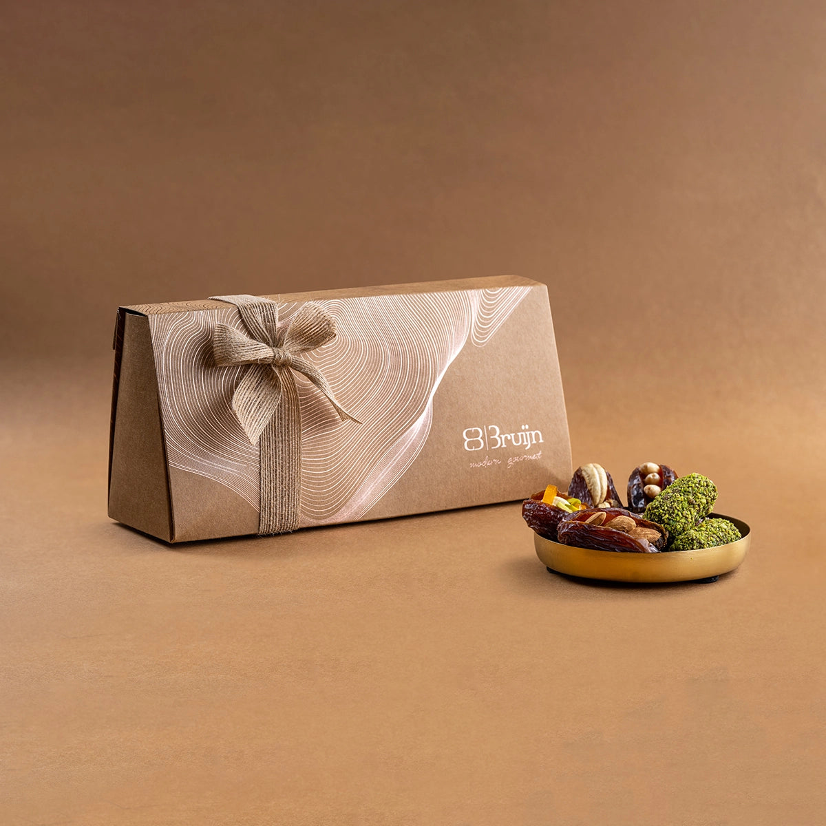 Medjool date gift pack with a small plate of stuffed dates displayed.