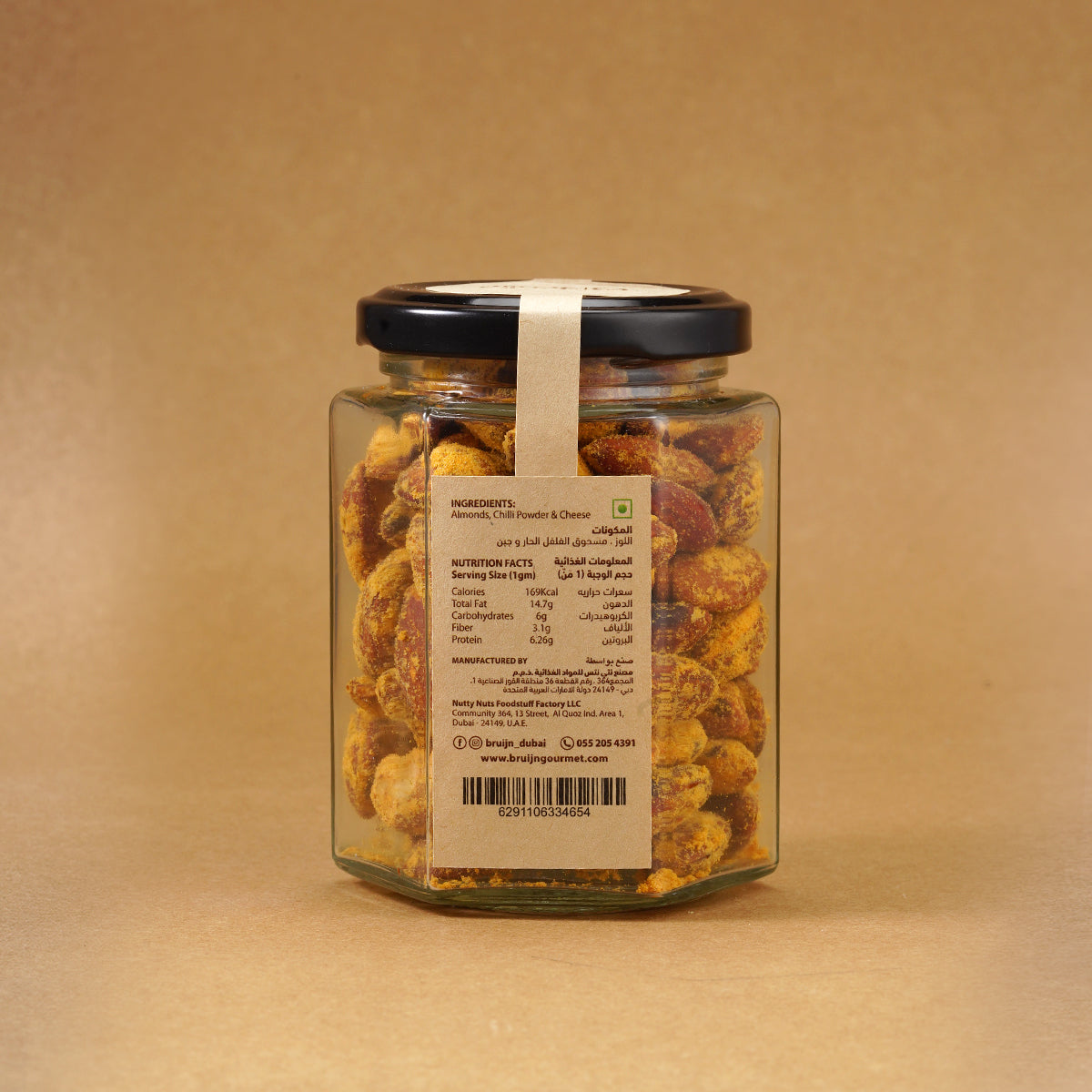 Glass jar of Bruijn Cheese & Chilli Almonds with a black lid and kraft label, showing golden almonds coated in cheese and chilli seasoning.
