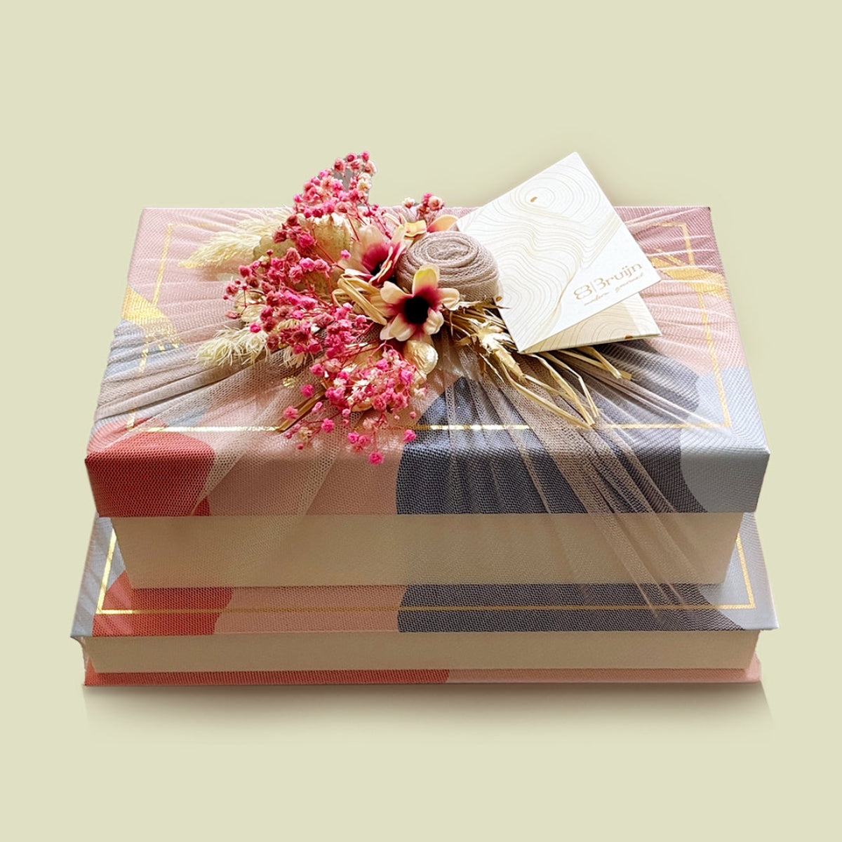 Elegant tower gift set with two festive boxes, wrapped in net fabric and adorned with pink flowers.