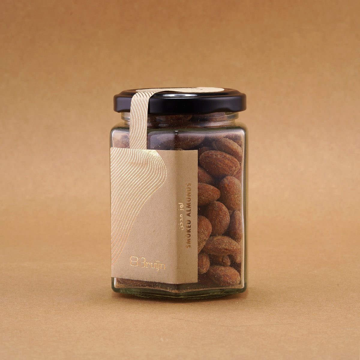 Glass jar of Bruijn Hickory Smoked Almonds with black lid and kraft label, filled with golden almonds infused with smoky hickory flavour.