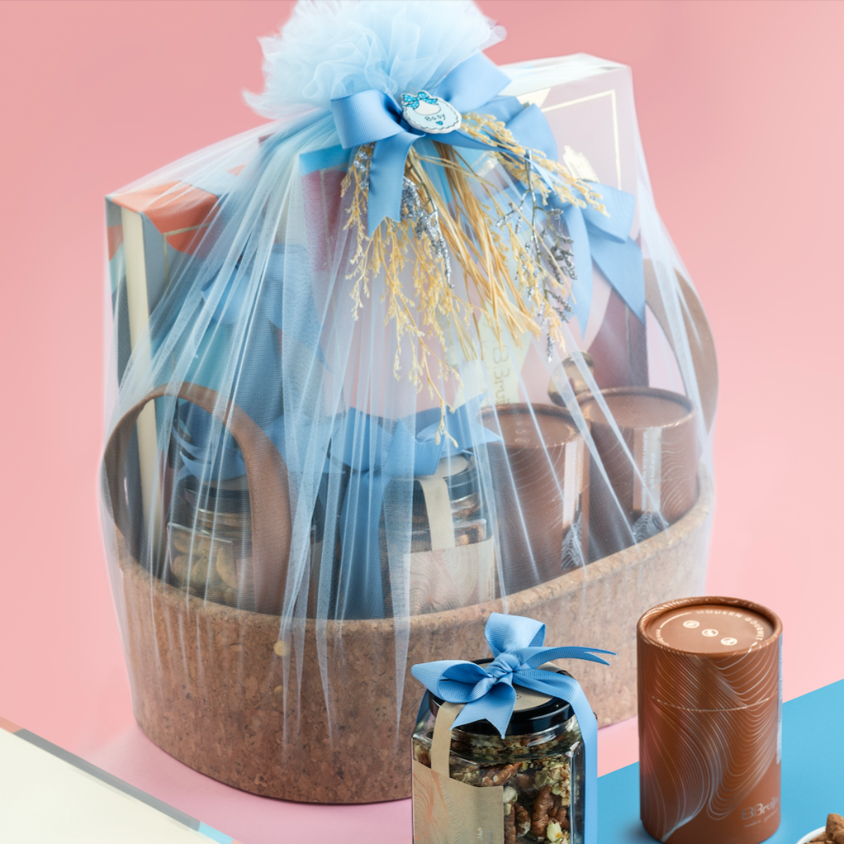 Luxury announcement basket with chocolates, figs, nuts, apple chips, and dates in premium gift packaging