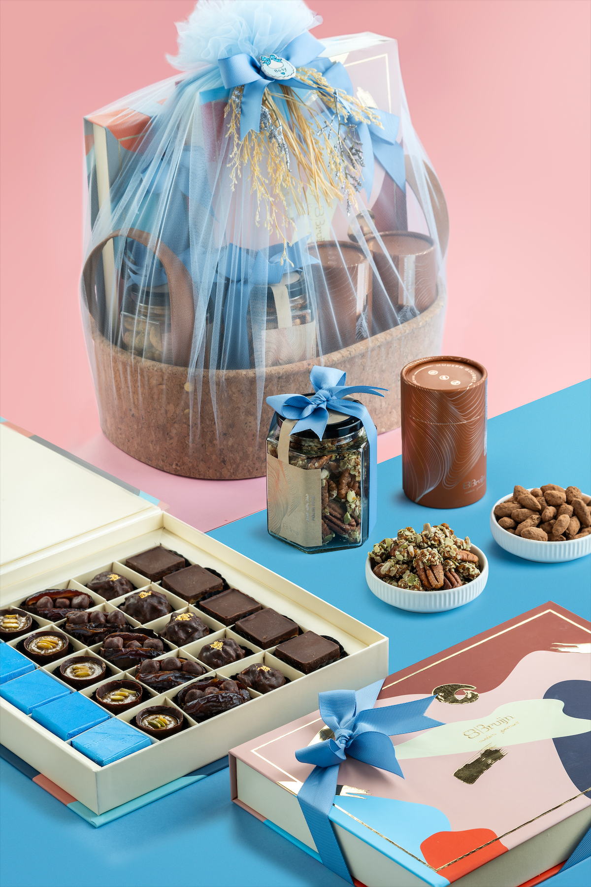 Luxury announcement basket with chocolates, figs, nuts, apple chips, and dates in premium gift packaging