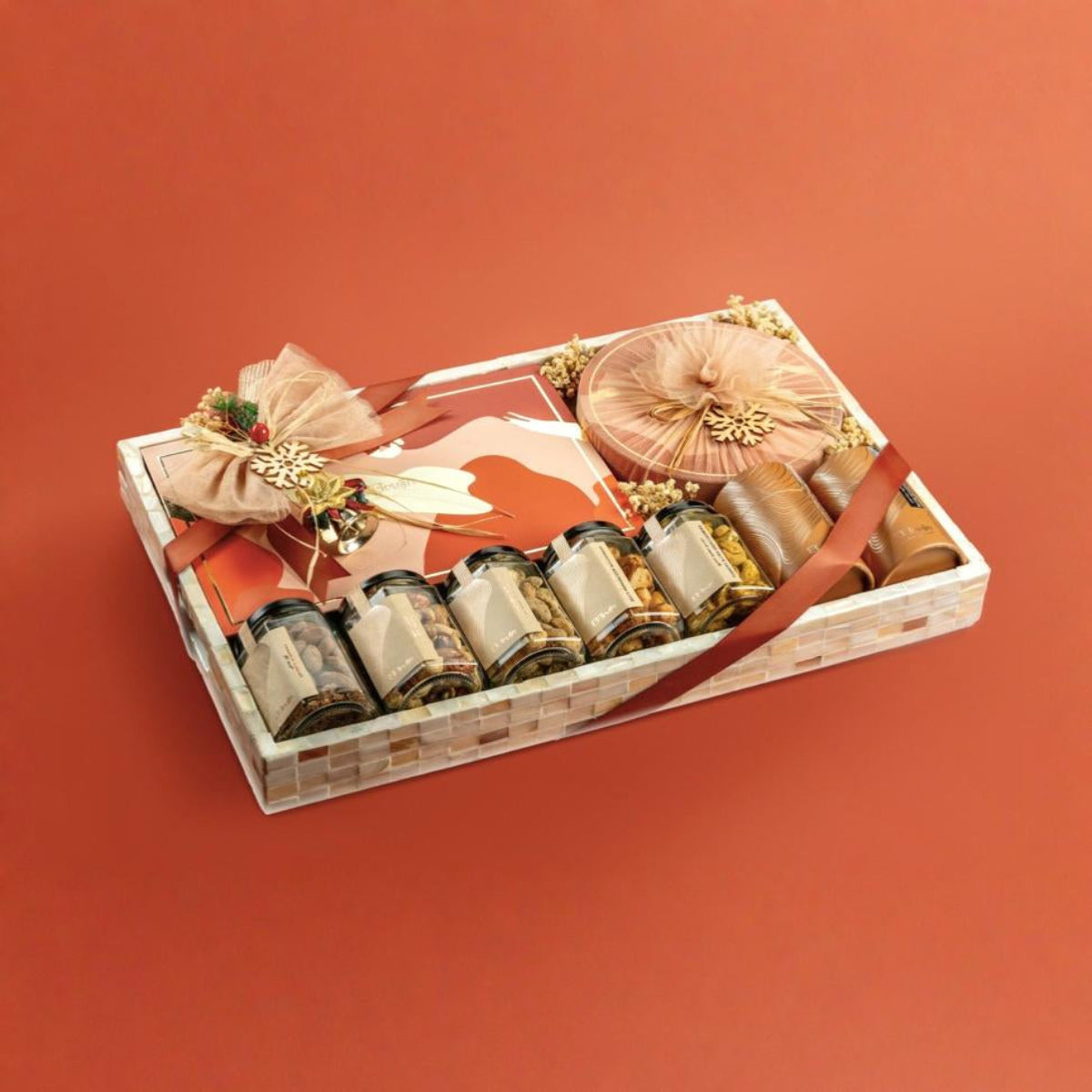 Gift basket with tea packages and decorative items on a red background