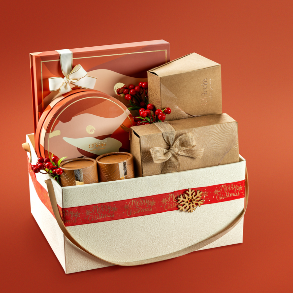 A decorative Christmas gift basket with a beige and red color scheme, containing various gourmet treats and presents.