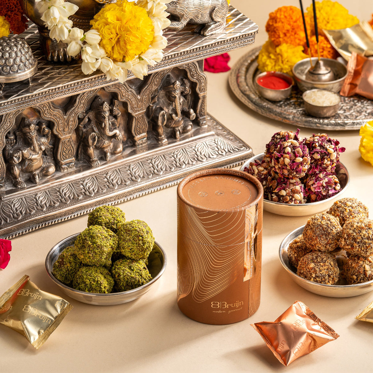Ganesh Chaturti Date Truffles by Bruijn - Elegant and compact, these cylinders are perfect for party favors or intimate giveaways — a small token that leaves a lasting impression.