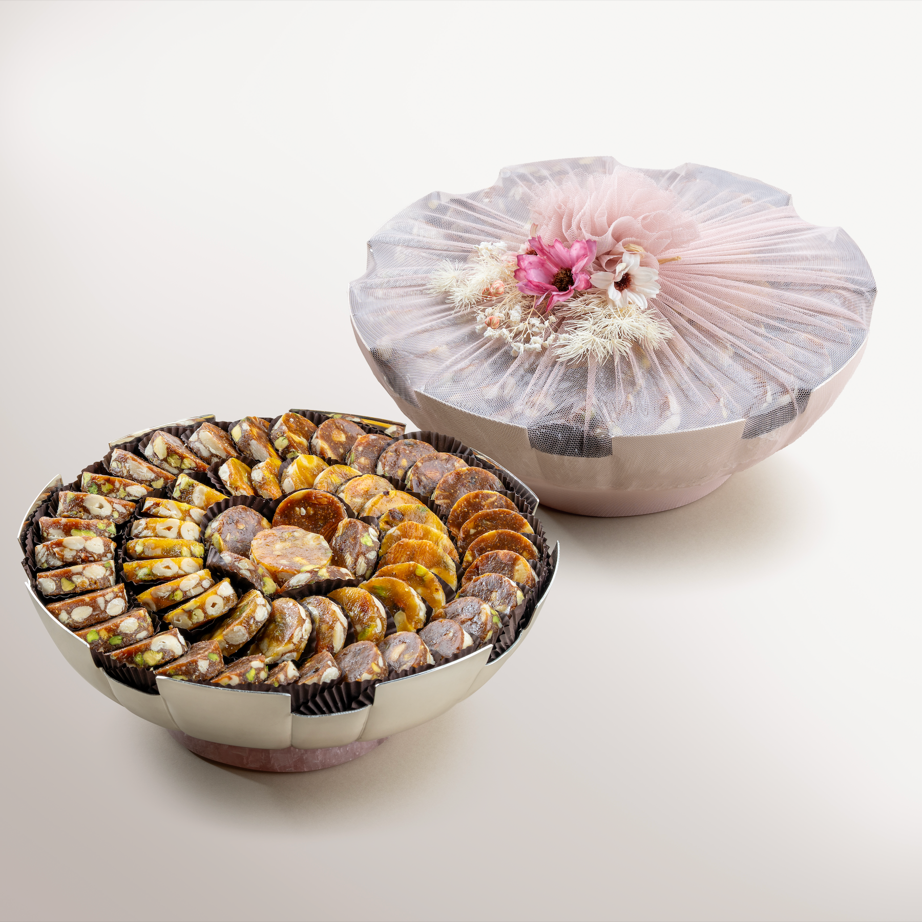 Fluted Silver bowl with Rose Quartz wrapped in net, filled with fig & apricot nut delights.