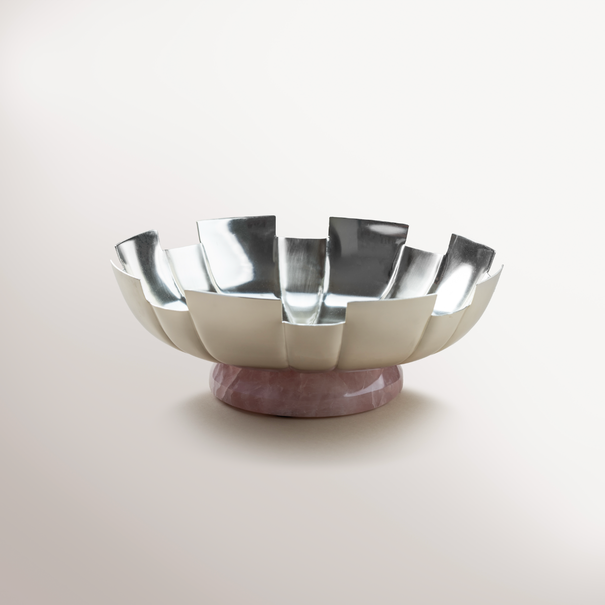 Fluted Silver bowl with Rose Quartz filled with artisanal fig and nut bites alongside pure cacao dark chocolate with nuts, beautifully arranged for gifting.