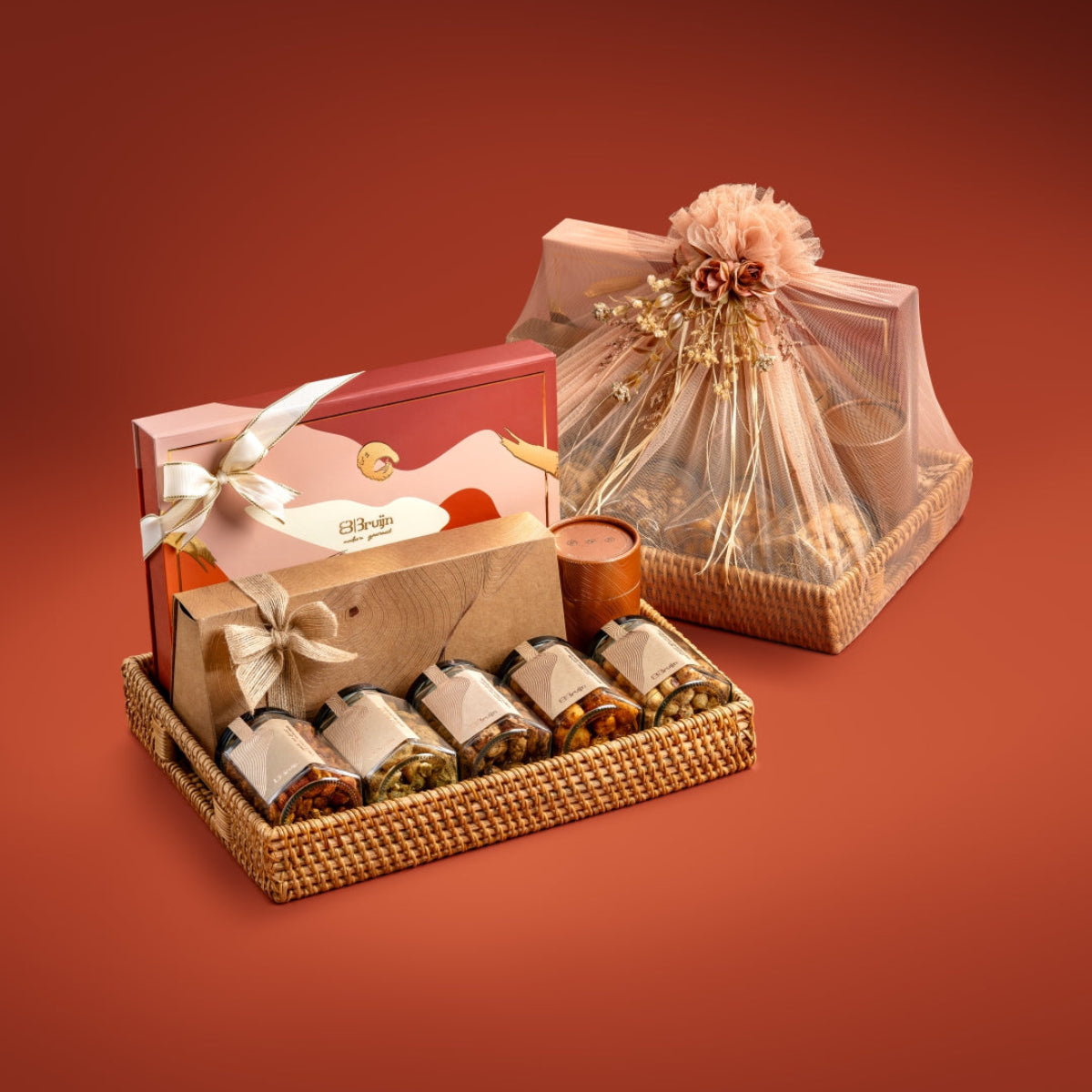 Elegant rattan tray with regal and craft boxes, nut jars, and apple chips, wrapped for gifting.