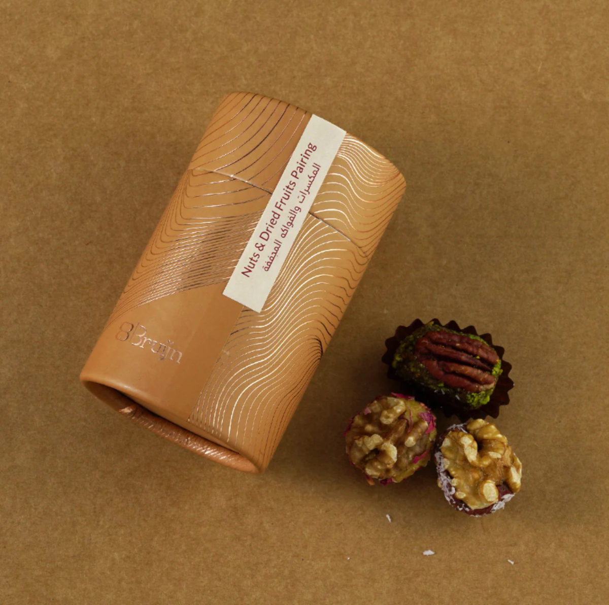 Cylinder pack of pecan, walnut, and dried fruit wholes.