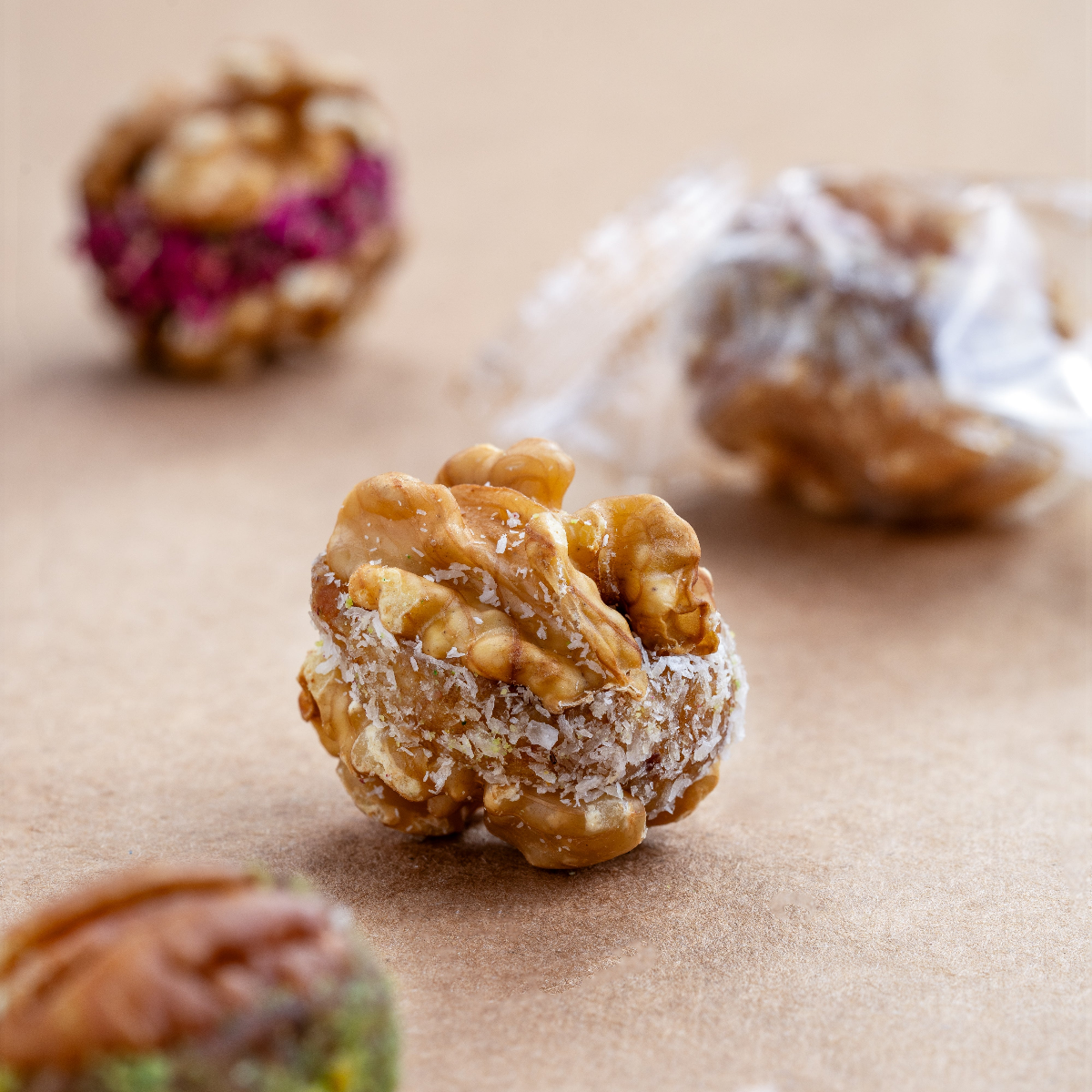 Assorted pecan bites (1kg, 60–65 pcs) filled with dates & pistachio, vegan, gluten-free, keto-friendly, ideal for guilt-free indulgence & gifting.