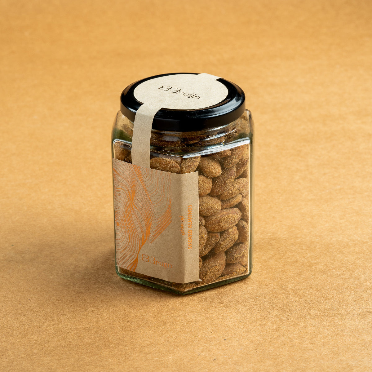 Glass jar of Bruijn Hickory Smoked Almonds with black lid and kraft label, filled with golden almonds infused with smoky hickory flavour.