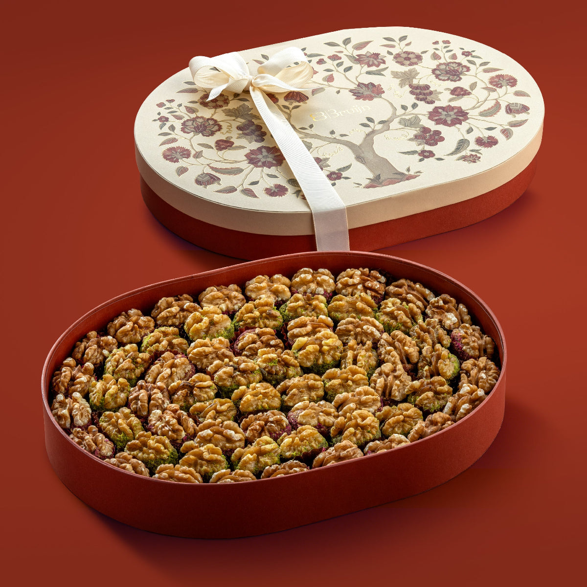 Tree of life gift box with 69 Chilean walnuts stuffed with dates & pistachio, neatly arranged in rows.