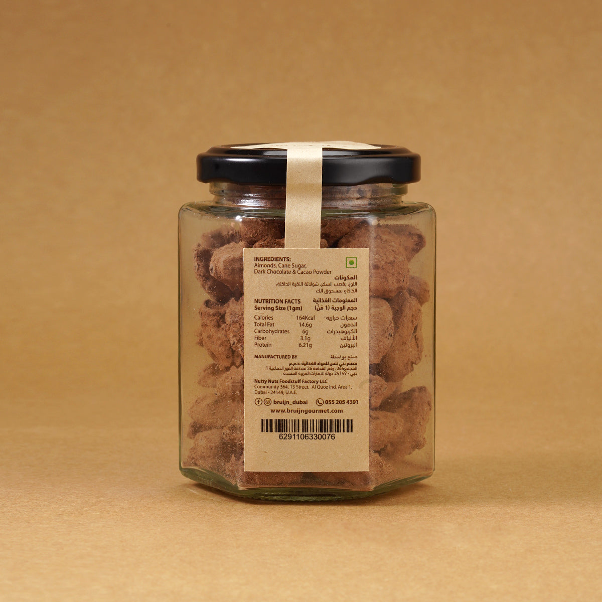 Glass jar of Bruijn Cocoa Dusted Almonds with black lid and kraft label, filled with chocolate-coated almonds dusted in rich cocoa powder.