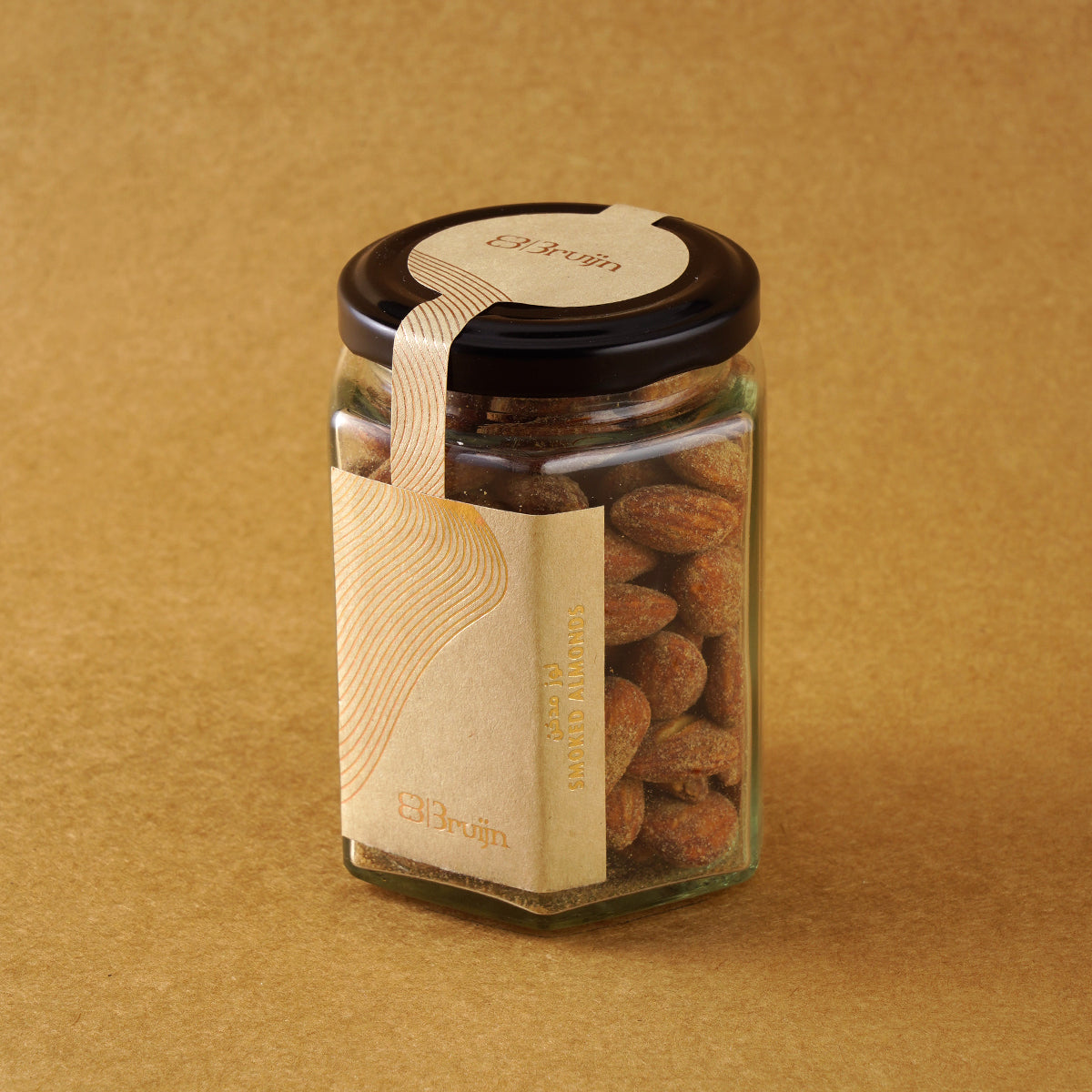 Glass jar of Bruijn Hickory Smoked Almonds with black lid and kraft label, filled with golden almonds infused with smoky hickory flavour.
