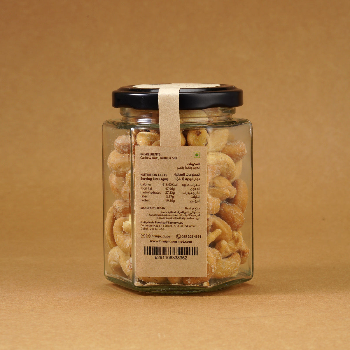 Glass jar of Bruijn Italian White Truffle Cashews with black lid and kraft label, filled with golden cashews coated in aromatic white truffle seasoning.